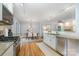 Bright open-concept kitchen flows into dining area with stylish light fixture at 917 Bobby Ln, Charlotte, NC 28211