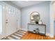 Welcoming entryway featuring hardwood floors, console table with decor, and a white front door at 917 Bobby Ln, Charlotte, NC 28211