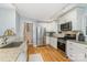 Updated kitchen features stainless steel appliances, granite counters, hardwood floors, and white cabinetry at 917 Bobby Ln, Charlotte, NC 28211