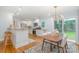Bright kitchen features stainless appliances, granite countertops, and a dining area with backyard access at 917 Bobby Ln, Charlotte, NC 28211