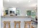 Modern kitchen featuring white cabinets, stainless steel appliances, and a breakfast bar at 917 Bobby Ln, Charlotte, NC 28211