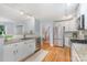 Well-lit kitchen with stainless steel appliances, granite countertops, and hardwood floors at 917 Bobby Ln, Charlotte, NC 28211