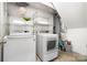 Functional laundry room with modern appliances and storage shelves at 917 Bobby Ln, Charlotte, NC 28211
