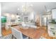Bright, open living and dining area with hardwood floors, contemporary lighting, and stainless appliances at 917 Bobby Ln, Charlotte, NC 28211