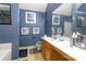 Full bathroom features a single sink vanity, a tub, a tile floor, and blue walls at 10228 Seedling Ln, Charlotte, NC 28214