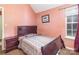 Bedroom featuring a window, nightstand, and bed with patterned comforter at 10228 Seedling Ln, Charlotte, NC 28214