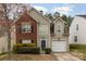 Inviting two-story home with a brick facade and siding, accented by trimmed greenery and a well-kept front yard at 10228 Seedling Ln, Charlotte, NC 28214