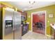 Galley kitchen with stainless steel refrigerator and range adjacent to the dining area at 10228 Seedling Ln, Charlotte, NC 28214