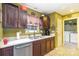 Functional kitchen with a double sink, white countertops, and stainless steel dishwasher, conveniently located near the laundry area at 10228 Seedling Ln, Charlotte, NC 28214