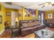 Inviting living room with leather sofas, a coffee table, and a staircase, perfect for relaxation at 10228 Seedling Ln, Charlotte, NC 28214