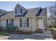 Charming home featuring gray siding, dark shutters, a dormer window and a brick foundation at 1057 Farm Pond Ln, Rock Hill, SC 29732