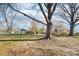Spacious backyard featuring mature trees, a storage shed, and a swing set for outdoor enjoyment at 108 Colonial Dr, Kings Mountain, NC 28086