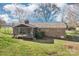 Backyard featuring a brick house with an enclosed patio and a green lawn at 108 Colonial Dr, Kings Mountain, NC 28086