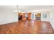 Bright, open living space with hardwood floors, brick fireplace, and a view to the kitchen at 108 Colonial Dr, Kings Mountain, NC 28086