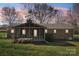 Back of home, featuring screened porch and brick exterior in a serene and private backyard setting at 108 Colonial Dr, Kings Mountain, NC 28086
