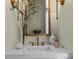 Elegant bathroom vanity with gold fixtures, a decorative mirror, and modern sink at 1158 South S St, Cornelius, NC 28031