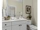 Charming bathroom featuring a white vanity, a decorative mirror, and stylish decor elements, enhancing the space at 1158 South S St, Cornelius, NC 28031