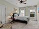 Inviting bedroom with a dark wood bed frame, soft carpet, and natural light streaming through the windows at 1158 South S St, Cornelius, NC 28031