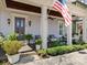 Inviting front porch with stylish seating, potted plants, and an American flag, perfect for relaxing at 1158 South S St, Cornelius, NC 28031