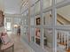 Hallway with a wall of mirrors, a pink settee, and a glimpse of the stairway and the kitchen at 1158 South S St, Cornelius, NC 28031