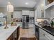 Well-equipped kitchen includes stainless steel appliances, custom cabinetry, and a large island at 1158 South S St, Cornelius, NC 28031