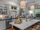 Modern kitchen boasts white cabinets, an island with seating, and stainless steel appliances at 1158 South S St, Cornelius, NC 28031