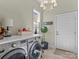 Well-equipped laundry room featuring modern washer and dryer units, a folding counter, and ample storage space at 1158 South S St, Cornelius, NC 28031