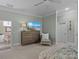 A bedroom featuring neutral colors, a flat-screen TV, and a seating area at 1158 South S St, Cornelius, NC 28031
