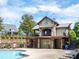 Community pool with modern pool house featuring covered balcony, seating, and meticulous landscaping at 1158 South S St, Cornelius, NC 28031