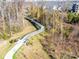Aerial view of a scenic walking bridge surrounded by lush trees and foliage at 1158 South S St, Cornelius, NC 28031