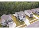 An aerial view showcases three new homes with landscaped yards and a backdrop of lush green trees at 1195 Cavalier Ln, Rock Hill, SC 29730
