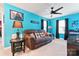 Comfortable bedroom with a sofa, unique decor, and vibrant blue walls at 1195 Cavalier Ln, Rock Hill, SC 29730