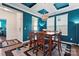 Stylish dining room with turquoise paint, modern light fixture, and seating for six at 1195 Cavalier Ln, Rock Hill, SC 29730
