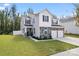 Well-manicured lawn and stone accents enhance the curb appeal of this two-story home with a two-car garage at 1195 Cavalier Ln, Rock Hill, SC 29730