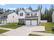 Charming two-story home features a modern design with a two-car garage, stone accents, and manicured lawn at 1195 Cavalier Ln, Rock Hill, SC 29730