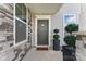 Inviting front entrance with a gray door, stone accents, and decorative planters for added curb appeal at 1195 Cavalier Ln, Rock Hill, SC 29730