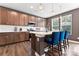 Well-lit kitchen featuring wood cabinets, stainless steel appliances, and a center island with breakfast bar at 1195 Cavalier Ln, Rock Hill, SC 29730