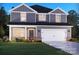 Charming two-story home with a two-car garage, complemented by manicured landscaping and a welcoming facade at 1265 Morehead Dr, Salisbury, NC 28144