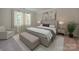 Serene primary bedroom with neutral tones, a cozy sitting area, and natural light at 1265 Morehead Dr, Salisbury, NC 28144