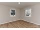 Neutral bedroom with newly installed flooring and two windows providing natural light at 1356 Ford Dr, Lowell, NC 28098