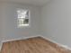Bedroom with refinished wood flooring and a view through the window at 1356 Ford Dr, Lowell, NC 28098