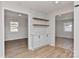 Stylish dining area with built-in cabinets, floating shelves, and hardwood floors, offering a cozy atmosphere at 1356 Ford Dr, Lowell, NC 28098