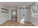 Charming dining area with barn door, stylish cabinets, and shelving for a modern feel at 1356 Ford Dr, Lowell, NC 28098