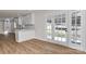 Open kitchen with white cabinets, breakfast bar, and stainless steel appliances next to a bright dining area at 1356 Ford Dr, Lowell, NC 28098