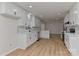 Spacious open-concept kitchen featuring white cabinets, stainless steel appliances, and a breakfast bar at 1356 Ford Dr, Lowell, NC 28098