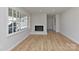 Bright living room with refinished fireplace, new windows, and laminate flooring at 1356 Ford Dr, Lowell, NC 28098