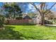 Spacious backyard featuring lush green lawn and mature trees, offering plenty of room to enjoy the outdoors at 1626 Beverly Dr, Charlotte, NC 28207