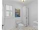 Bathroom featuring black and white patterned tile floors, toilet, sink and large storage cabinet at 1626 Beverly Dr, Charlotte, NC 28207