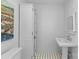 Bathroom featuring storage, patterned tile, and natural light at 1626 Beverly Dr, Charlotte, NC 28207