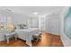 Bright bedroom with hardwood floors, two windows, and a large bed at 1626 Beverly Dr, Charlotte, NC 28207